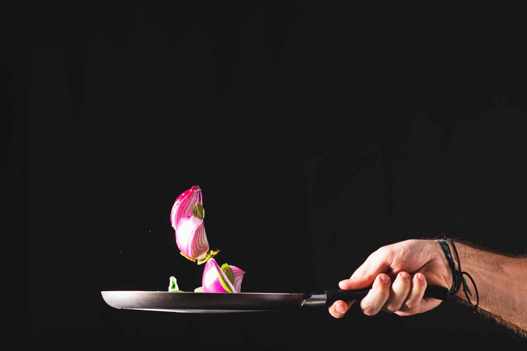 Chef plating a colorful modern dish on a slate